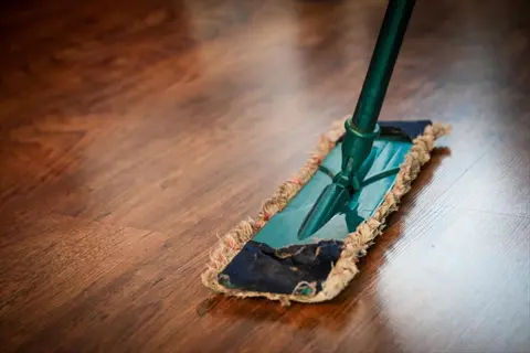 close-up of a mop on wooden floor during home cleaning