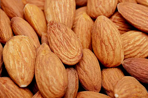 close-up of raw almonds whole nuts with textured brown skins