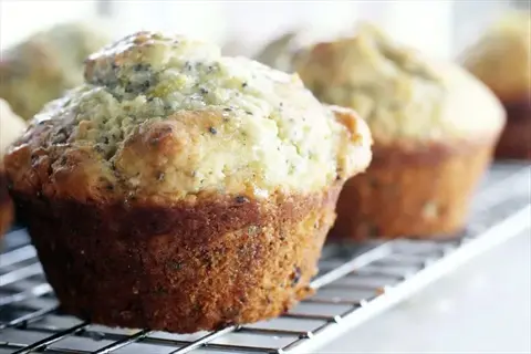 closeup of freshly baked chia muffins with visible seeds on a cooling rack, using chia as a healthy baking substitute