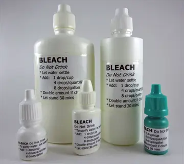 collection of bleach bottles with labels showing water purification instructions for sanitization