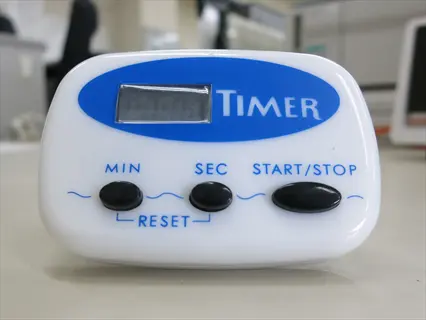 digital sound machine timer: white device with blue 'timer' header, lcd display, and buttons for min, sec, start/stop, reset. designed for scheduling audio sleep environments