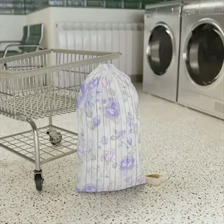 floral mesh laundry bag in shopping cart at industrial laundromat with washing machines