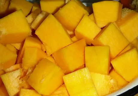 freshly cut pumpkin cubes (rich in beta-carotene) on a surface