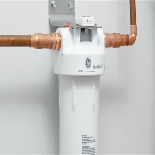 ge smartwater home water purification system with copper pipes installed on a wall