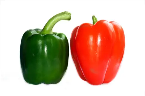 green and red bell peppers (excellent source of vitamin c) on white background