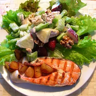 grilled salmon with walnuts in salad - rich in omega-3 fatty acids