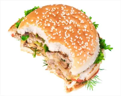 half eaten meal: partially consumed hamburger with sesame seed bun, visible fillings (lettuce, tomato, onion, sauce) on white background