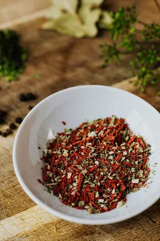 herbs spices bowl with dried seasoning mix on wooden surface - seasoning alternatives presentation