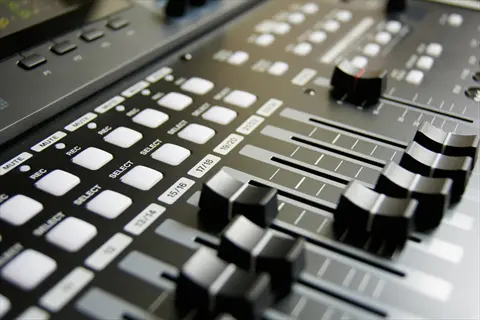 high quality sound machine: professional audio mixing console with faders, labeled channel buttons (mute, rec, select), and studio-grade sound processing controls