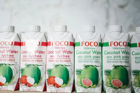 hydration coconut water: foco 100% pure cartons with lychee and pink guava flavors, featuring 'hydration by nature' text and fruit imagery