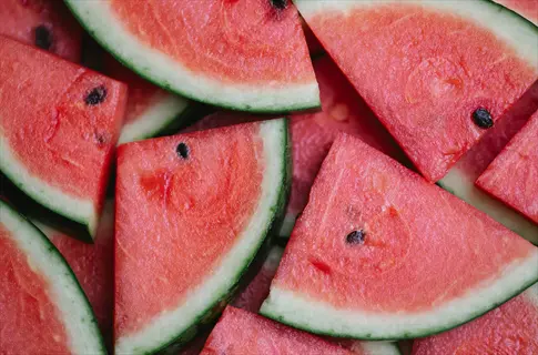 hydration-rich juicy watermelon chunks with vibrant red flesh, green rind, and dark seeds, showcasing refreshing freshness