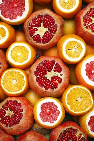 immune system citrus pomegranate: vibrant halved oranges, grapefruits and pomegranates rich in vitamin c and antioxidants