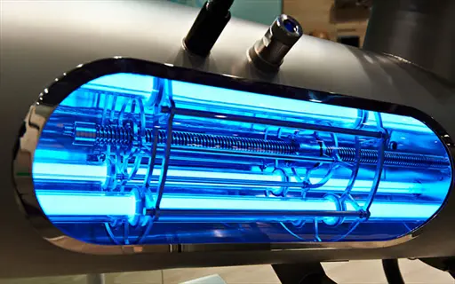 industrial uv light sanitization system with glowing blue treatment chamber