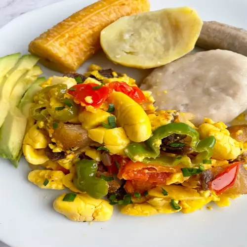 jamaican ackee and saltfish scramble with plantains, avocado, and boiled provisions; potassium-rich ackee balanced with sodium from salted cod