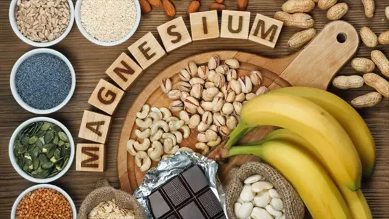 magnesium: assorted nuts, seeds, bananas, dark chocolate, and spinach as key dietary sources on wooden background