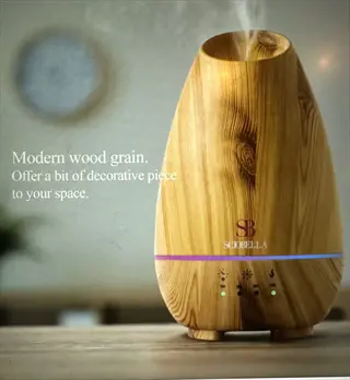 modern wood grain essential oil diffuser with soft - glowing base and steam output for aromatherapy in home decor