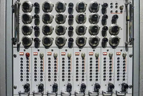 modular synthesizer sound machine controls: multiple rotary knobs, patch bays with numbered jacks (1-10), and labeled modules for analog sound routing and signal processing