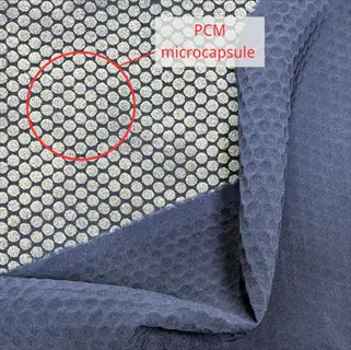 navy blue phase change fabric with hexagonal pcm microcapsules highlighted by red circle and labeled 'pcm microcapsule'