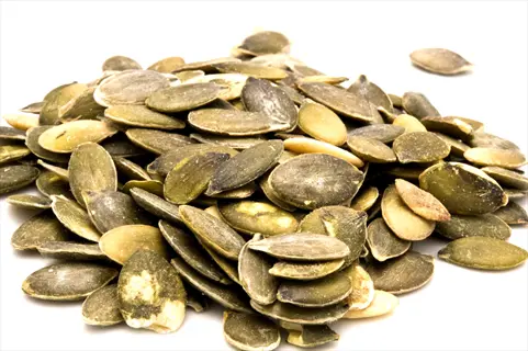 pile of raw pumpkin seeds, a key component in pumpkin sunflower seeds blends for seed cycling routines