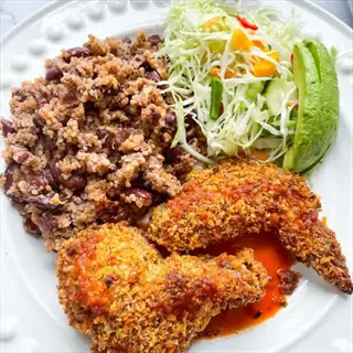 plate with crispy breaded chicken, quinoa-rice-bean blend, shredded cabbage salad with veggies, and sliced avocado - featuring gluten-free grains