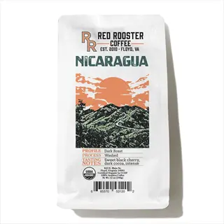 red rooster coffee nicaragua bag with usda organic certification, mountain landscape graphic, and product details