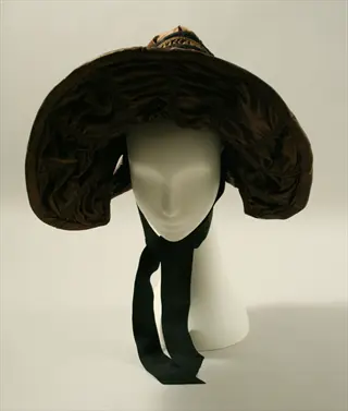silk hair bonnet: brown satin bonnet with black ribbon on mannequin head display