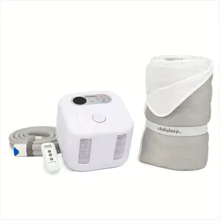 small white noise machine (chilisleep cooling system) with remote control and hose next to a rolled sleep mat for noise management