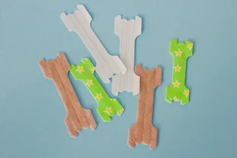 variety of nasal strips for application, featuring brown, white, and green star-patterned designs, illustrating nasal passage care
