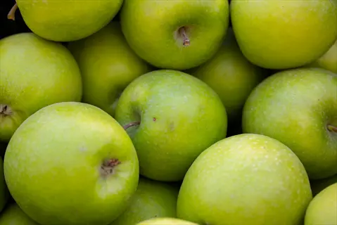 vibrant, juicy green apples fresh closeup in an abundant display
