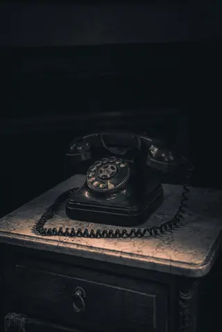 vintage rotary phone on an antique nightstand with a drawer, embodying digital detox through retro communication