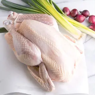 whole pesticide free chicken with fresh leeks and red onions, emphasizing reduced chemical exposure in meat